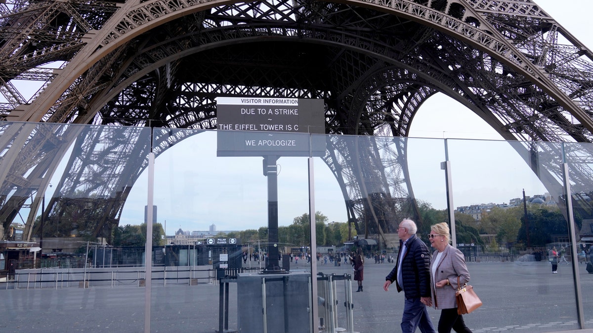 people walking by closed eiffel tower