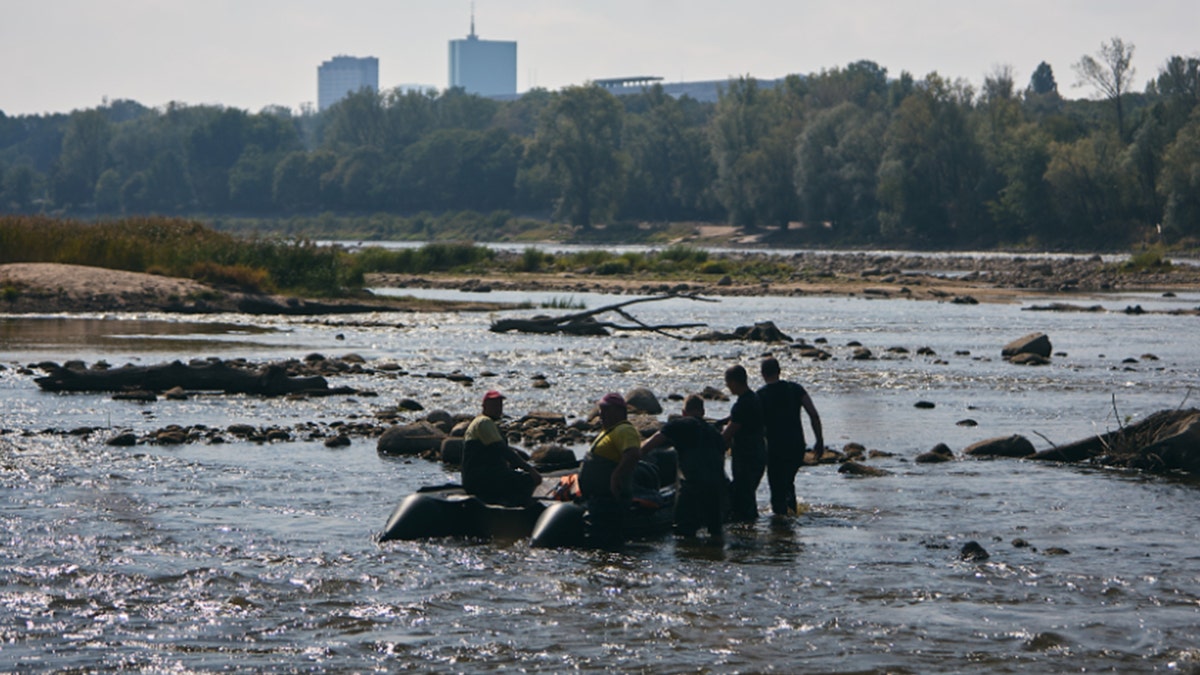 Archaeologists pulling things from river