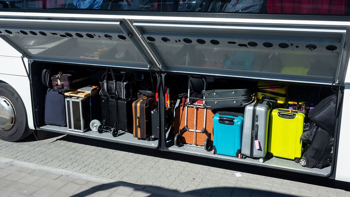 Suitcases loaded onto a bus.
