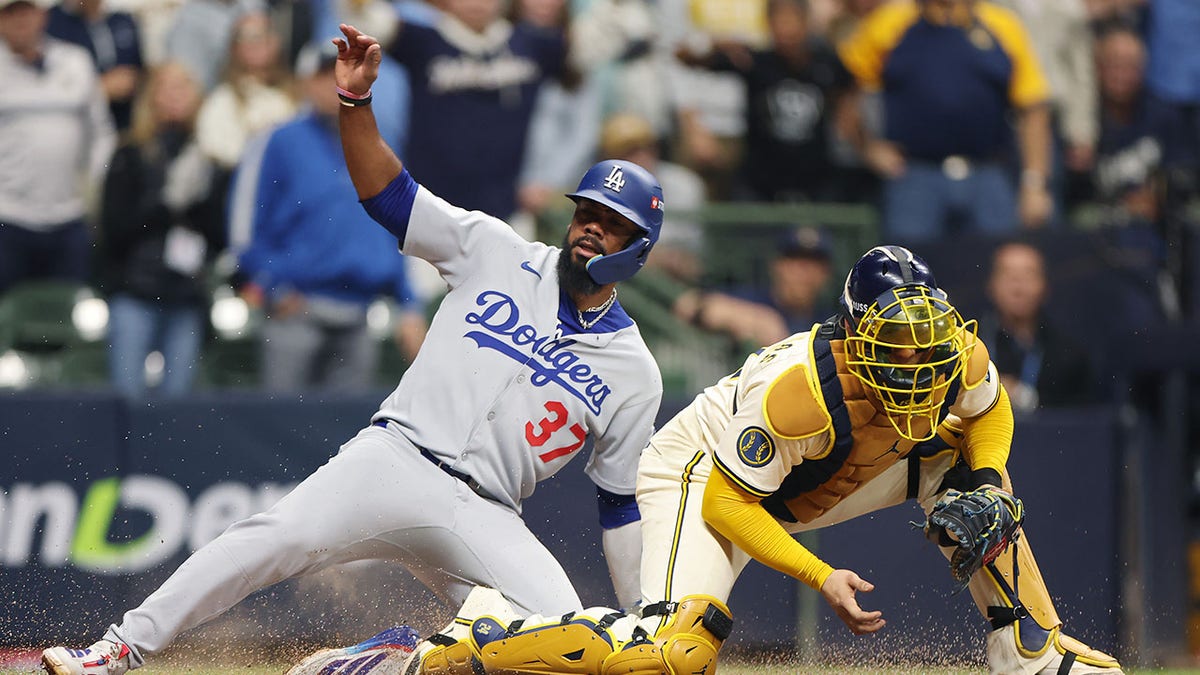 Teoscar Hernandez and Williams Contreras at home plate