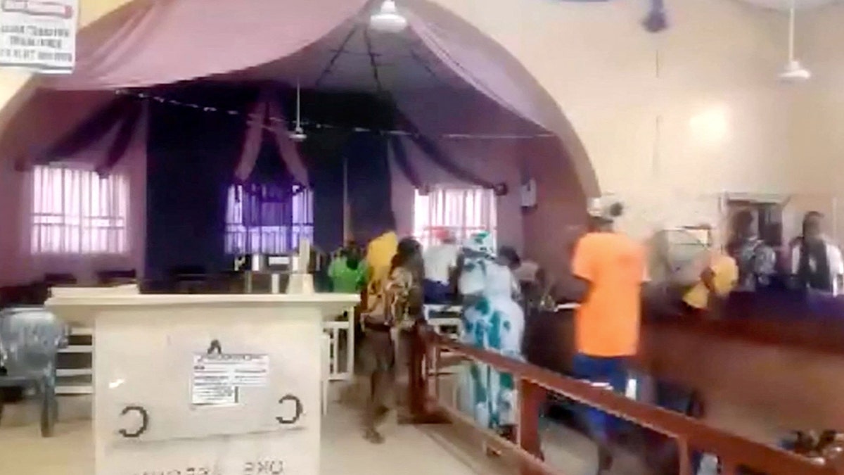 Worshippers run for cover in a Nigerian church