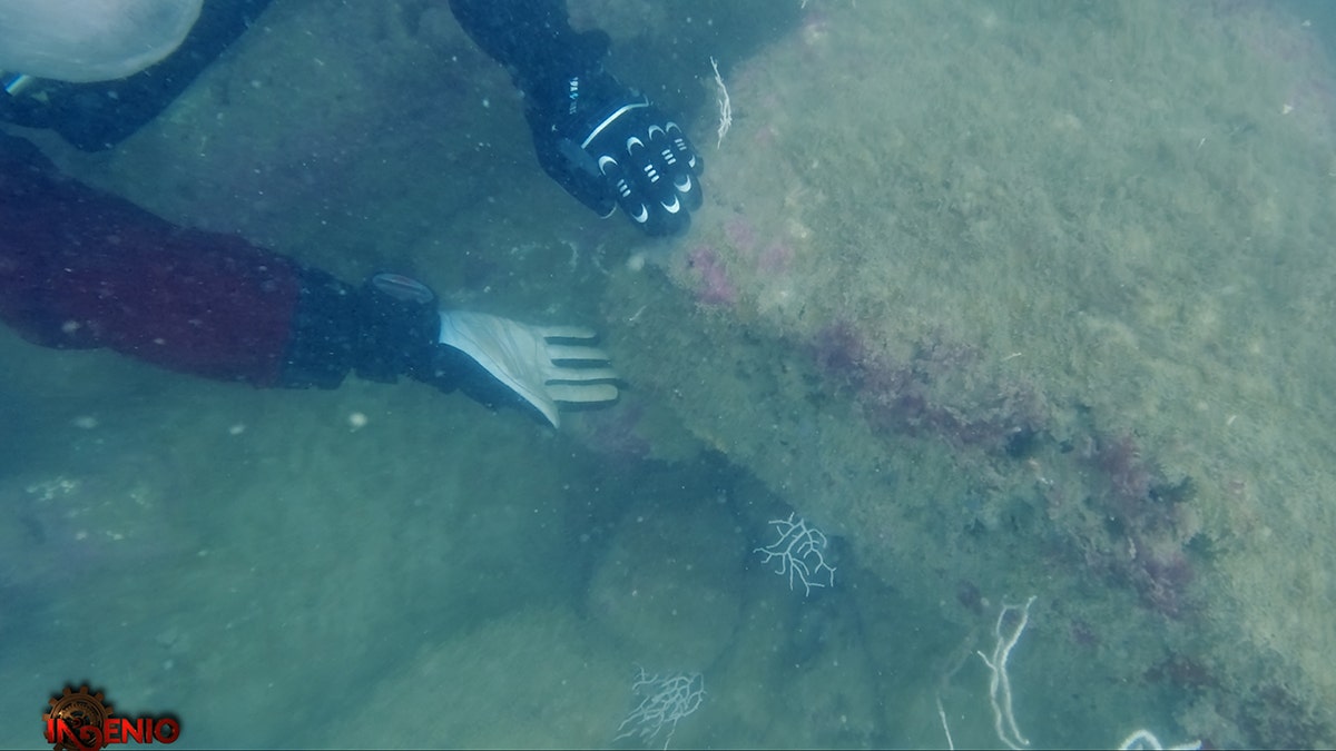 Hands showing ancient structure underground