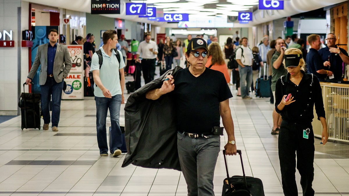 Man walking with luggage at St. Louis Airport