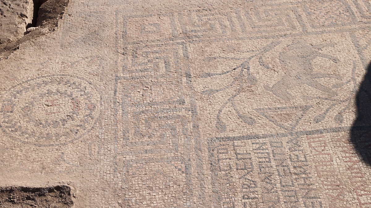 Geometric patterns on ancient mosaic.