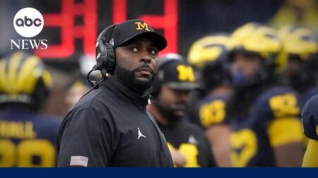 Fired University of Michigan football coach charged with home invasion, stalking