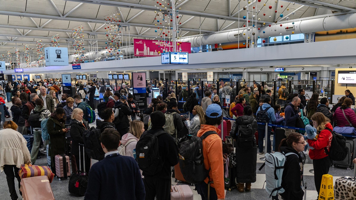Holiday travelers at Chicago airport in busy terminal