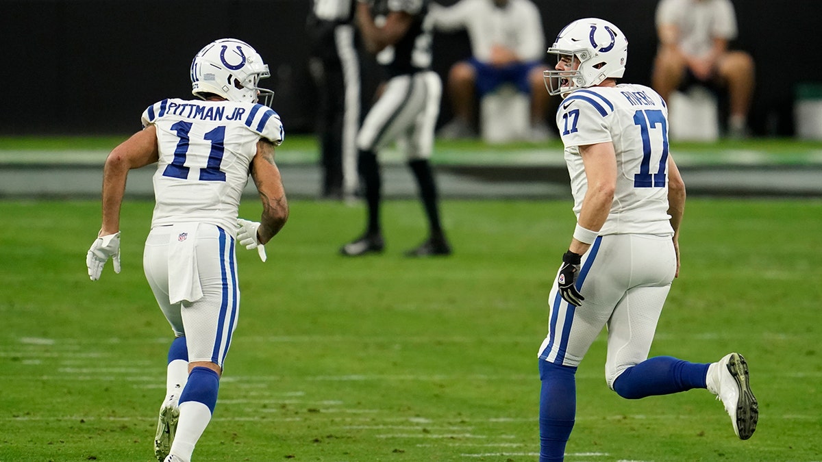 Philip Rivers and Michael Pittman Jr. run on field