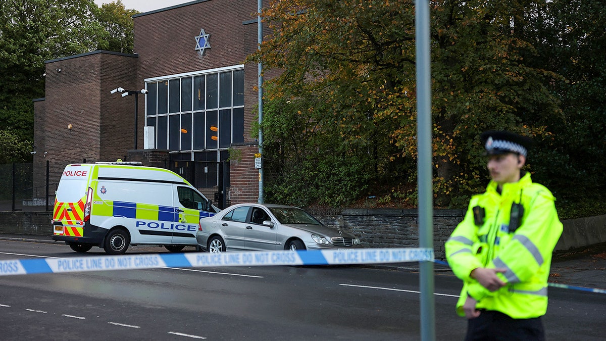 Police officer stands near Manchester synagogue