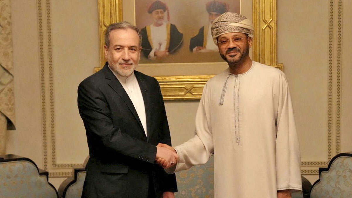 Abbas Araghchi and Badr al-Busaidi shake hands