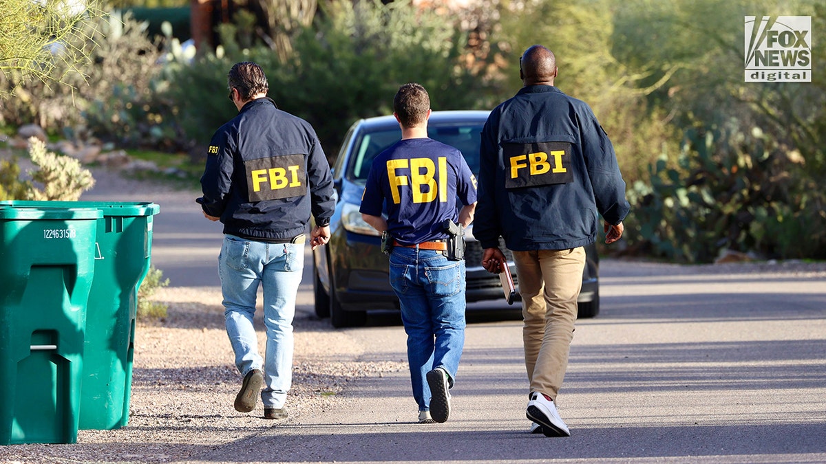 FBI agents canvassing a residential neighborhood near Nancy Guthrie's home.