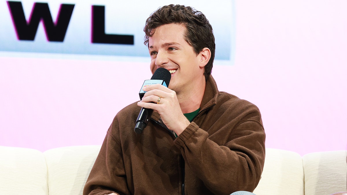Charlie Puth speaks into microphone