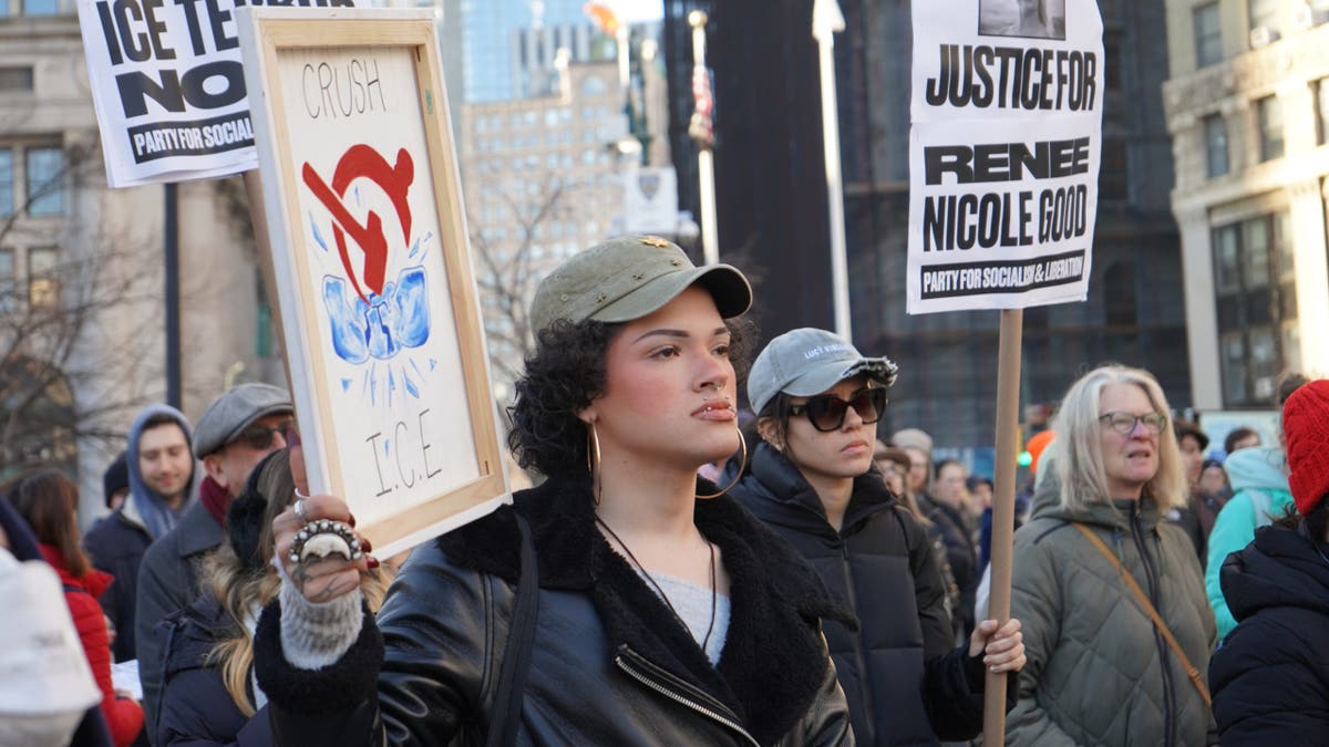 Protester joins a demonstration against ICE in New York City the day after the killing of Renee Good.