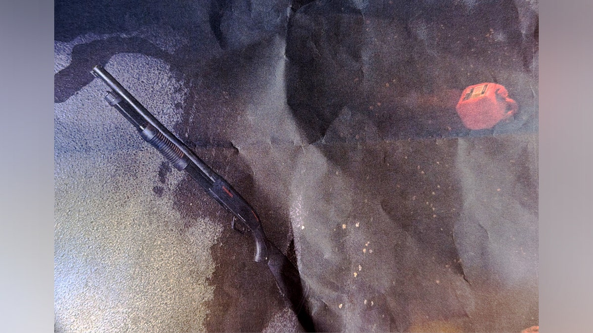 A shotgun sits next to what appears to be a fuel can