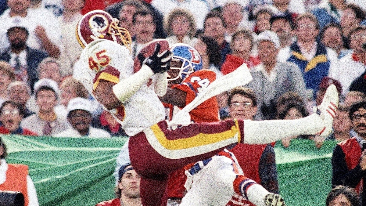 Barry Wilburn intercepts a pass