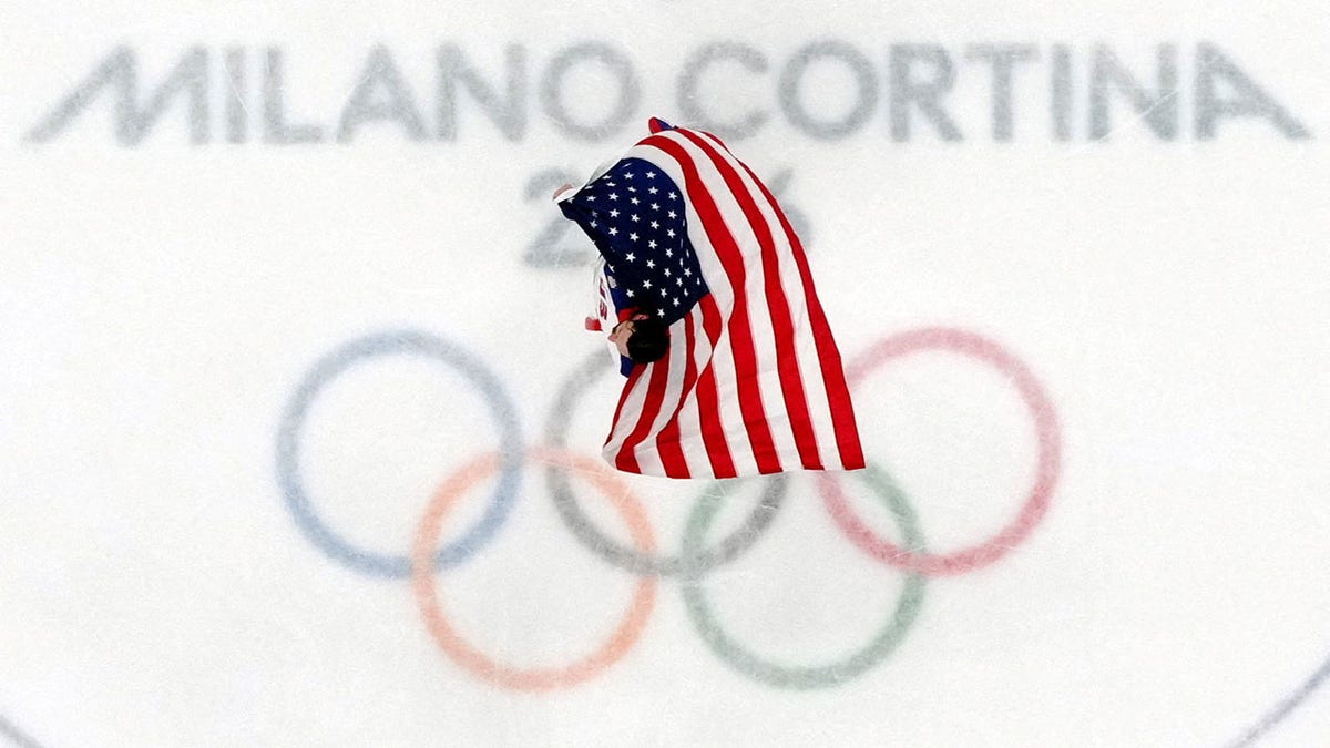 Connor Hellebuyck with the flag