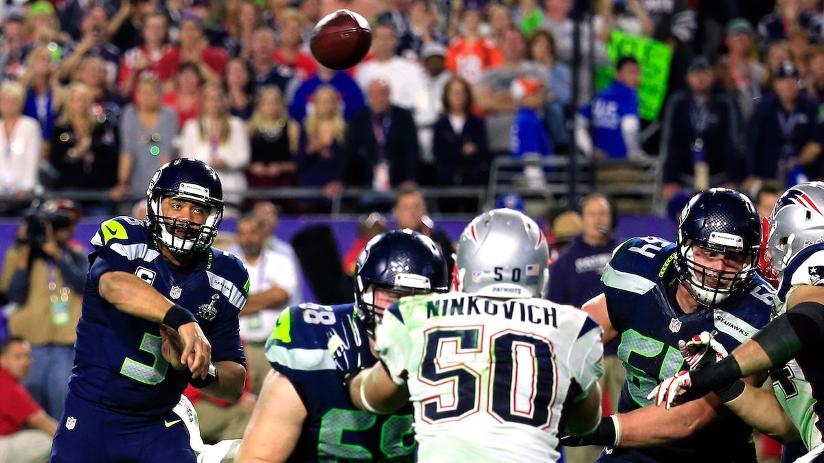 Russell Wilson has a pass intercepted by Malcolm Butler late in the fourth quarter during Super Bowl XLIX at University of Phoenix Stadium on Feb. 1, 2015 in Glendale, Arizona.