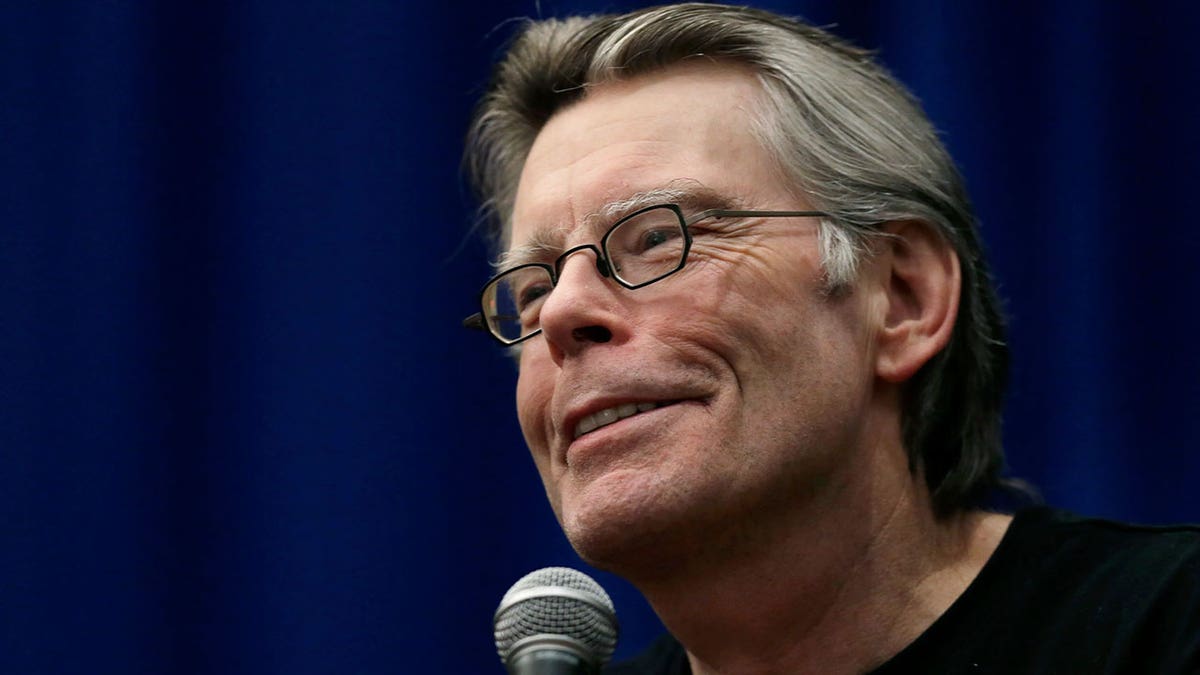 Stephen King holding microphone