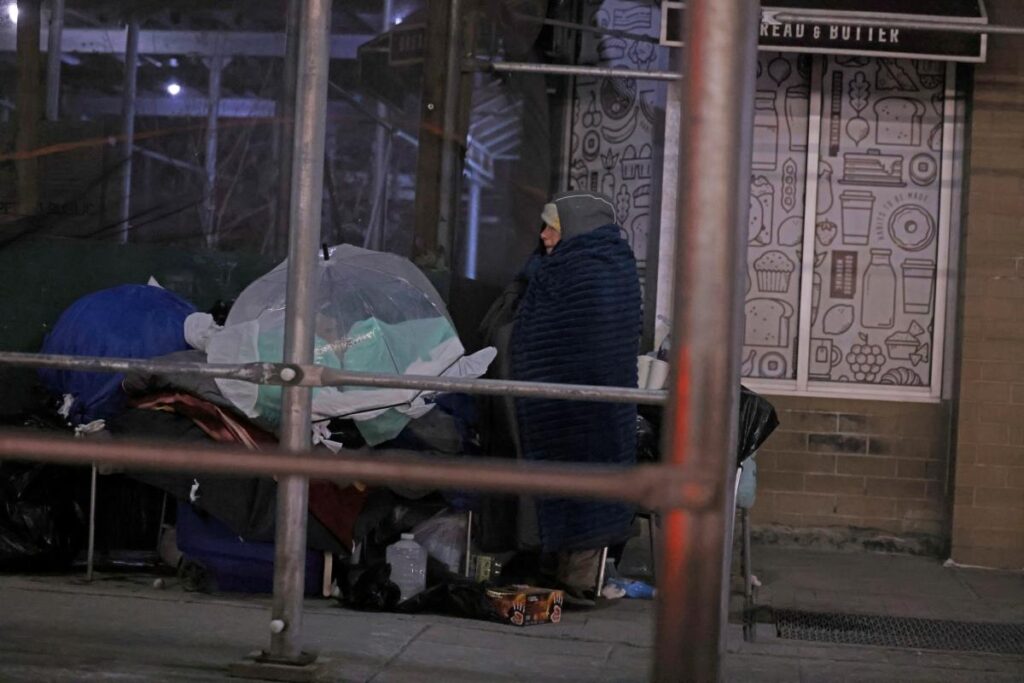 Exclusive | Mumbling homeless woman left to spend bone-chilling night on NYC sidewalk — with city workers saying their ‘hands are tied’