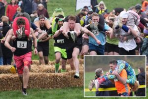 Finnish pair wins a barrel of ale in annual ‘wife-carrying’ contest in England