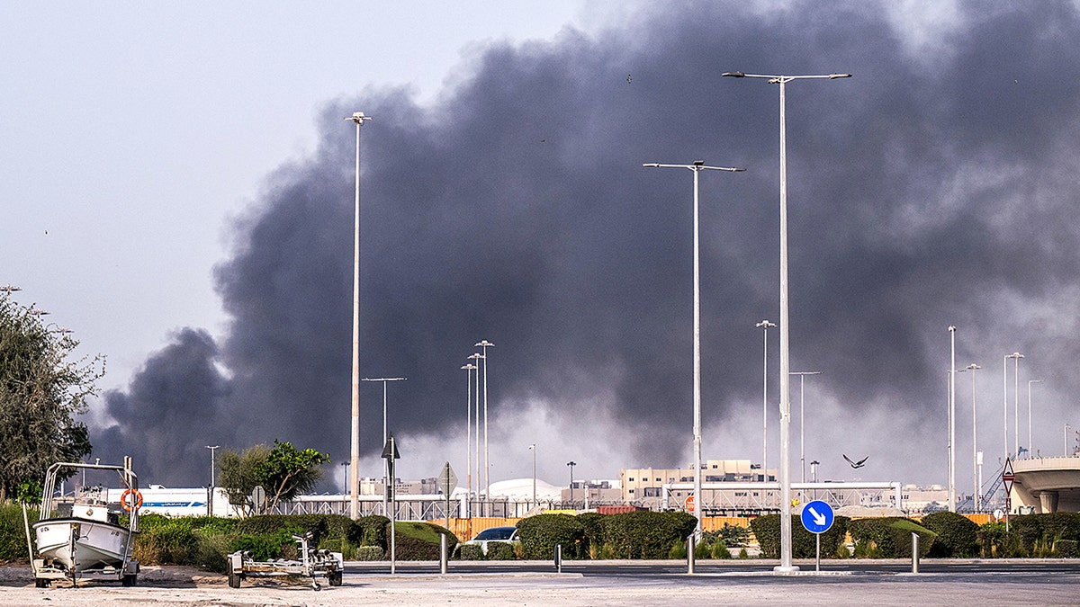 smoke rising over a coastal town in the UAE