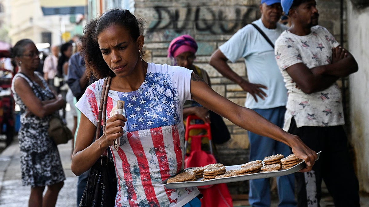 Cuban woman holding a tray of baked goods