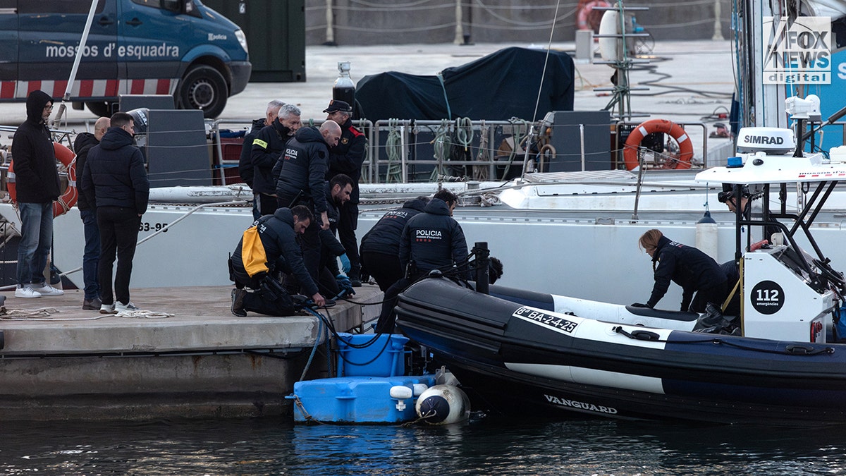 Catalan police officers recover the remains of Alabama student James Gracey.