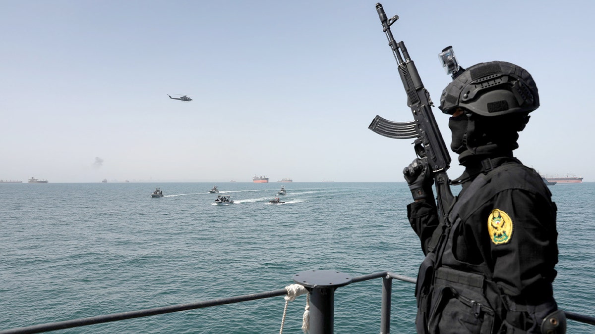 Warships maneuver off the coast of southern Iran during a joint maritime exercise.
