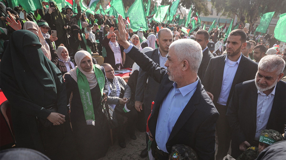Sinwar waving at a group of supporters at a rally.