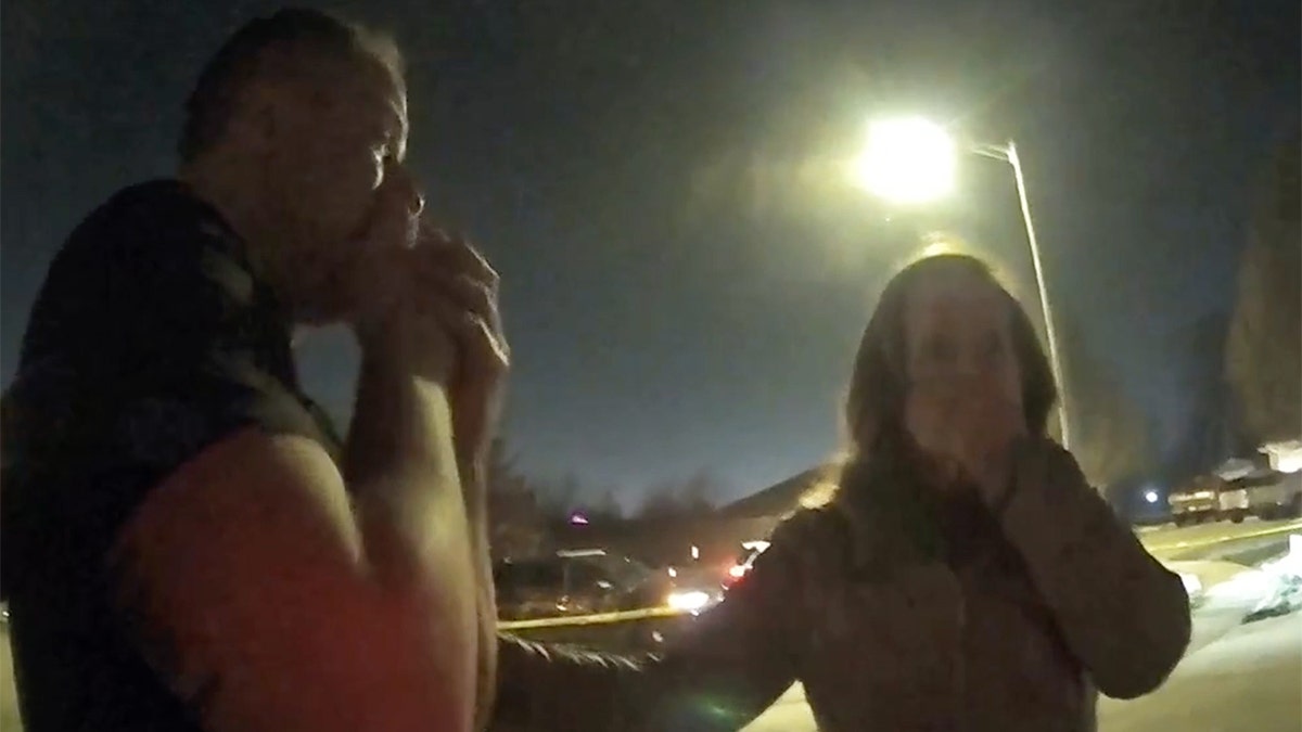 Caleb Flynn and a woman cry in bodycam video.