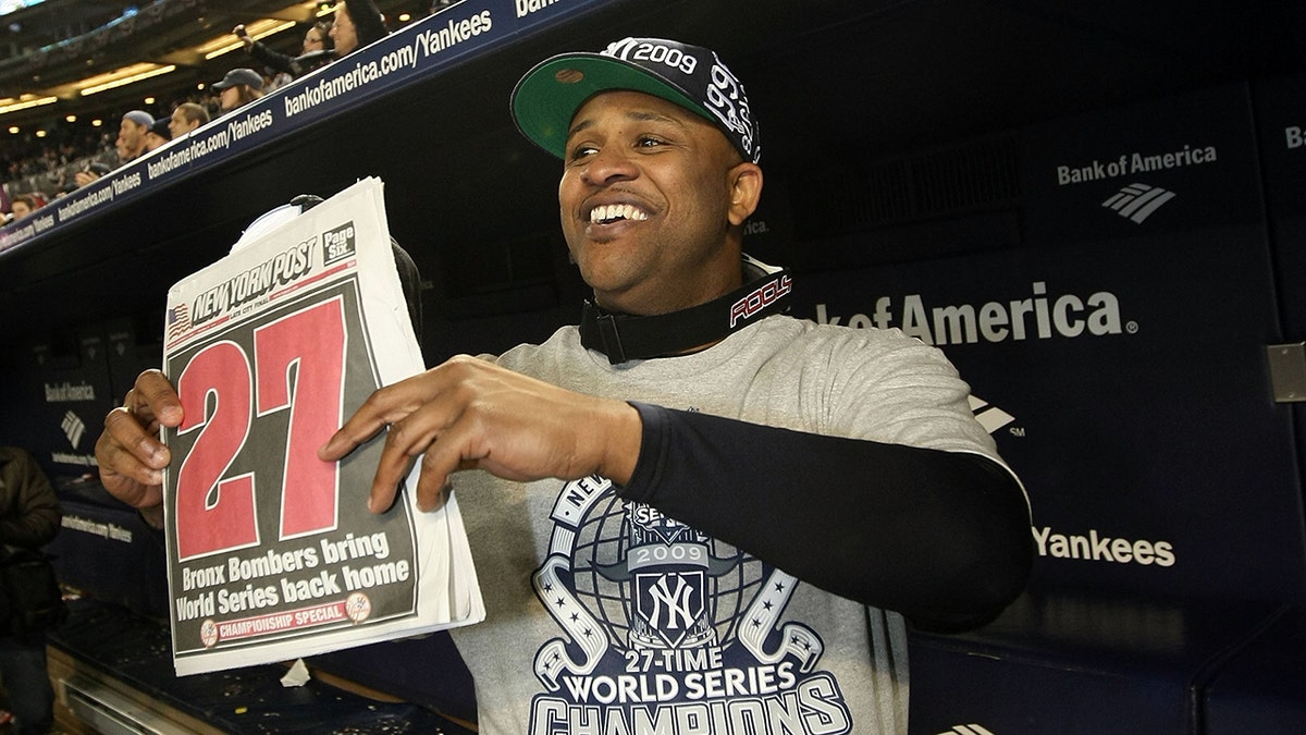 CC Sabathia poses with World Series news cutout