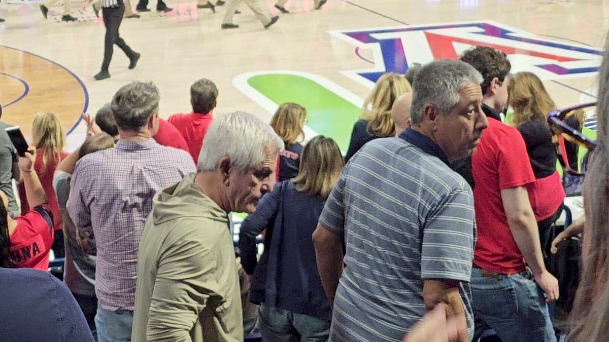 Chris Nanos leaving seat at basketball game