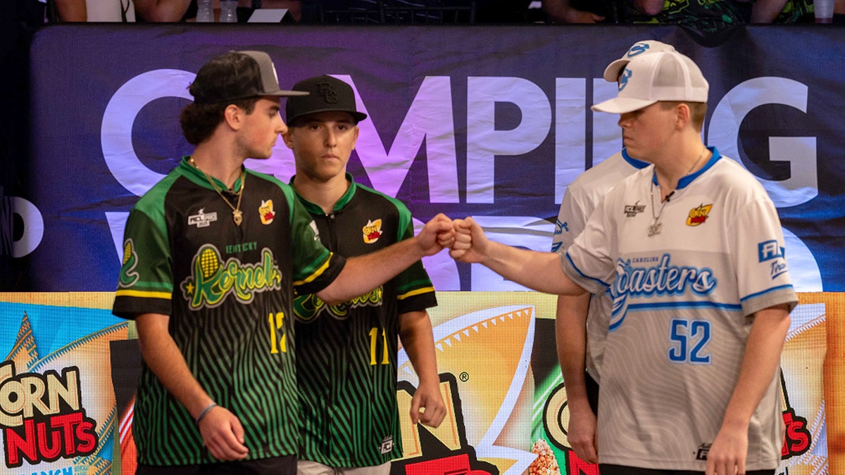 Cornhole players fist bump