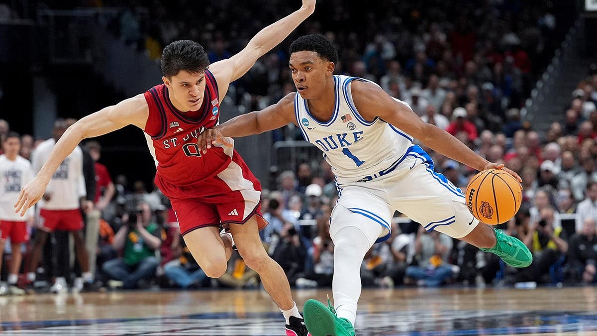 Duke guard Caleb Foster driving past St. John's guard Dylan Darling during basketball game