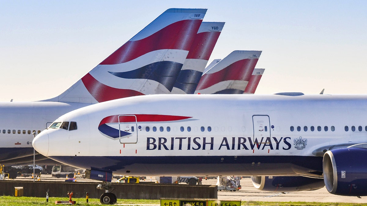 British Airways Boeing 777 taxiing for take off, surrounded by other planes
