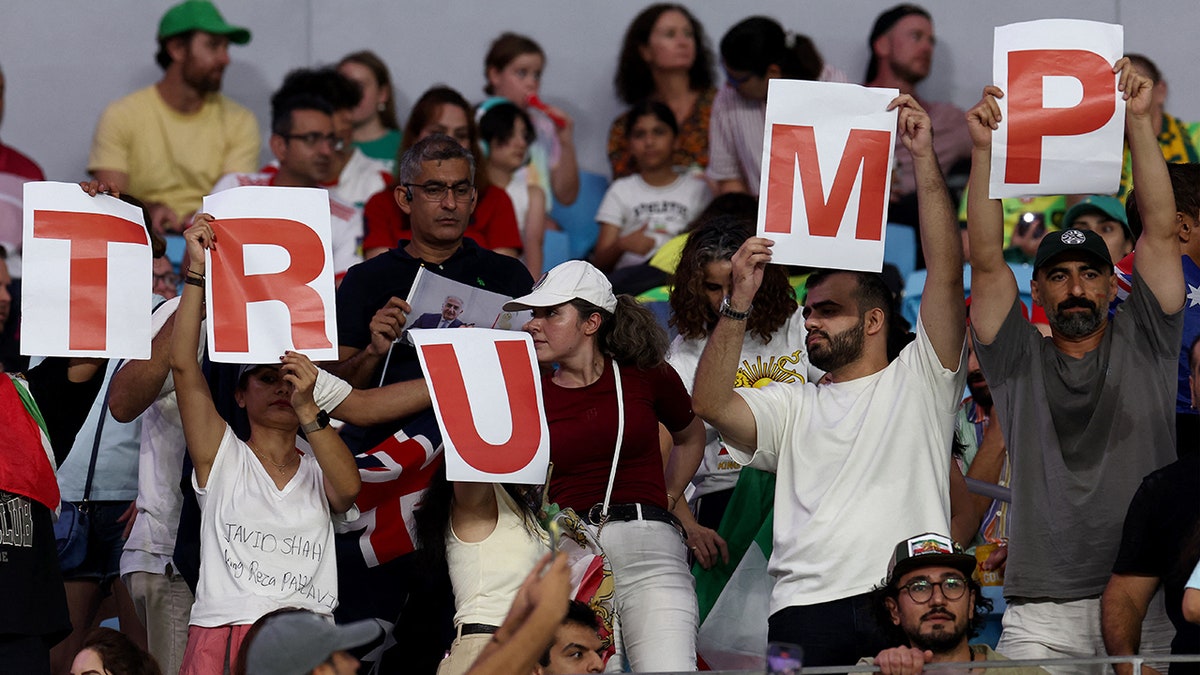 Iranian supporters display signs expressing support for U.S. President Donald Trump