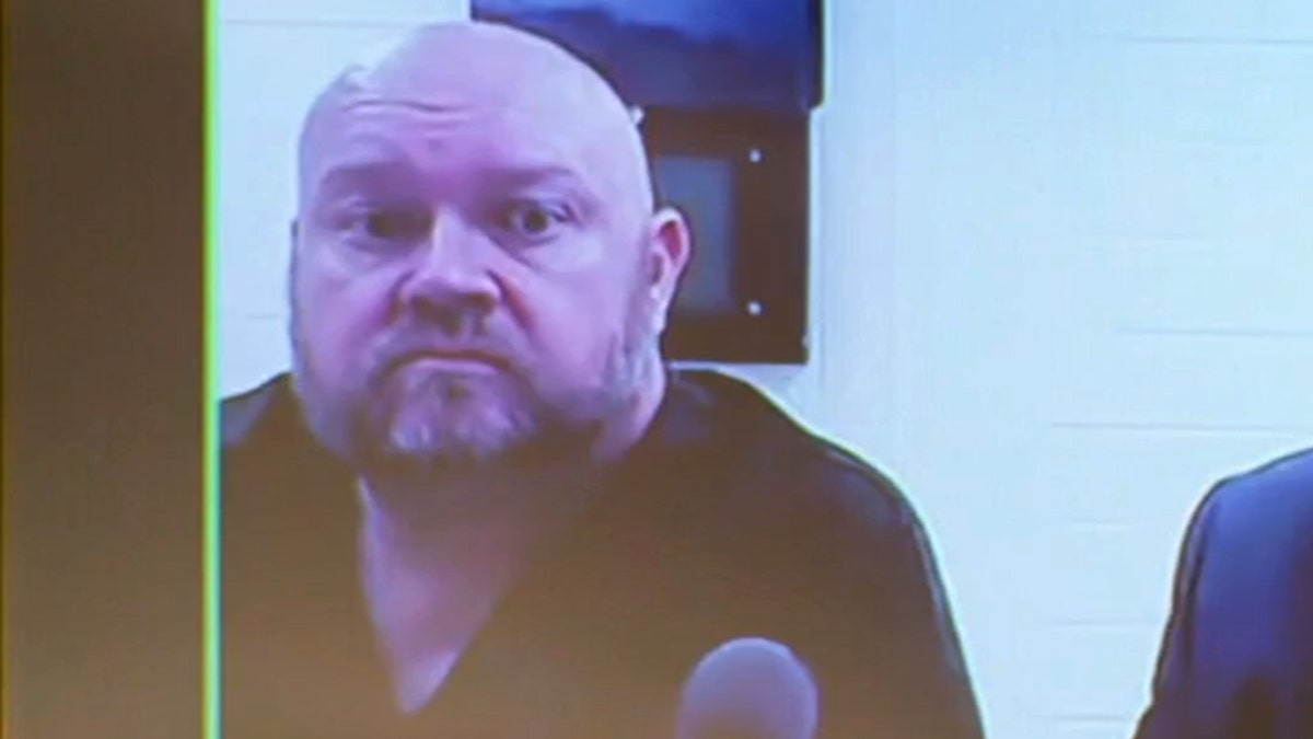 Former principal Jeremy P. Williams shown on a screen during a court appearance.