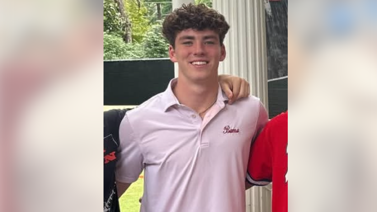 Jimmy Gracey wearing a pink "Bama" polo shirt in an undated family photo.