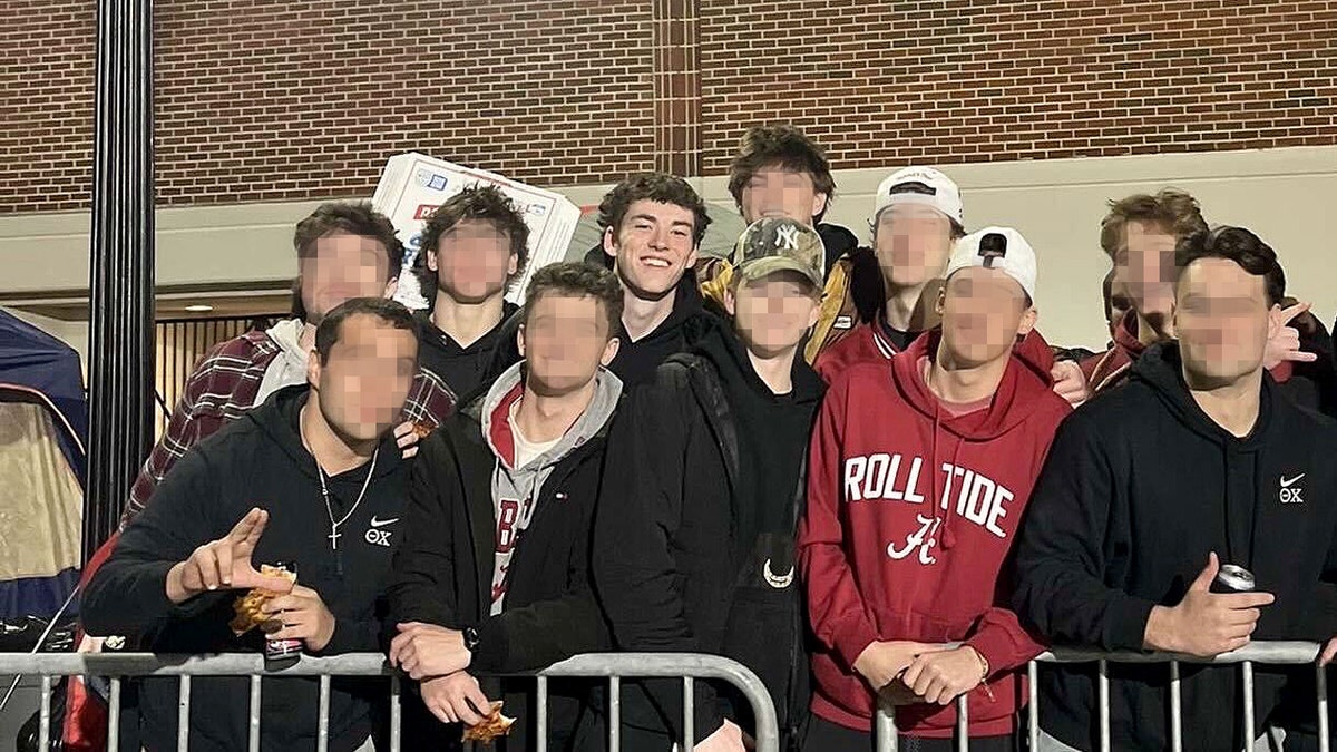 Jimmy Gracey and unknown people standing next to him