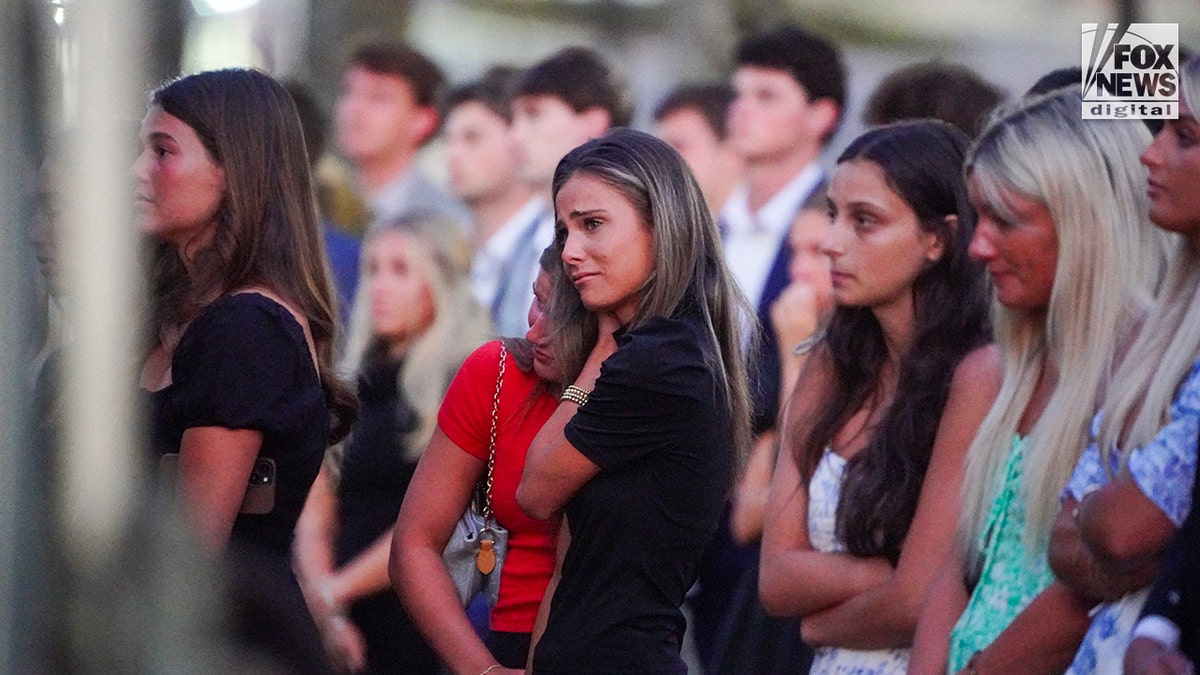 Mourners at a memorial vigil for Jimmy Gracey standing together