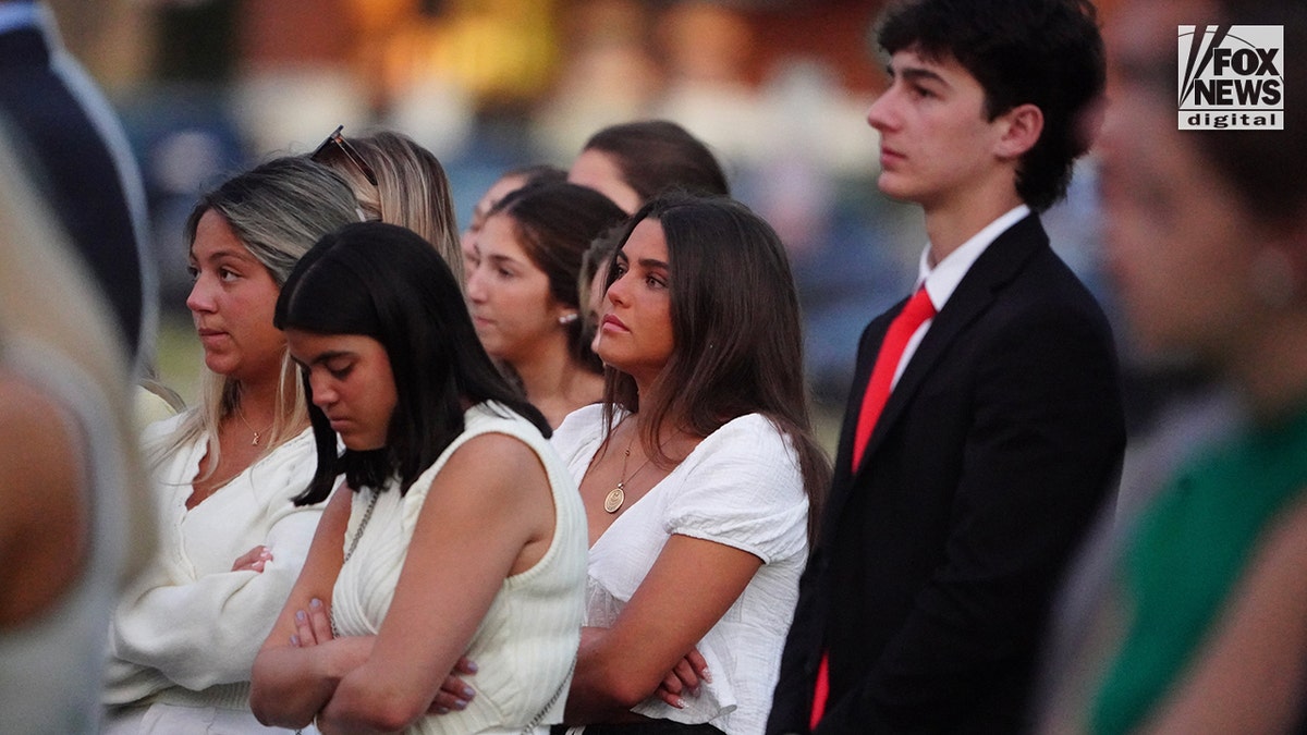 Mourners at a memorial vigil for Jimmy Gracey standing together