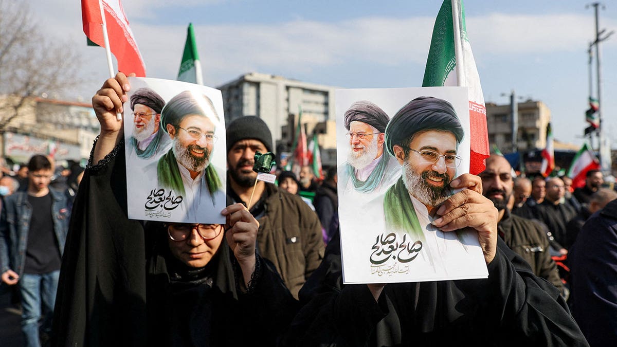 placards with an image of Iran's new supreme leader Mojtaba Khamenei with late Iranian Supreme Leader Ayatollah Ali Khamenei