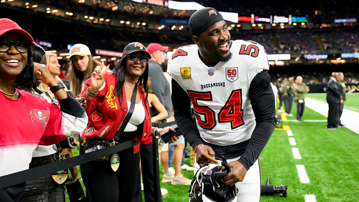 FILE - Tampa Bay Buccaneers linebacker Lavonte David (54) with his family before an NFL football game against the New Orleans Saints, Oct. 26, 2025, in New Orleans. (AP Photo/Ella Hall, File)
