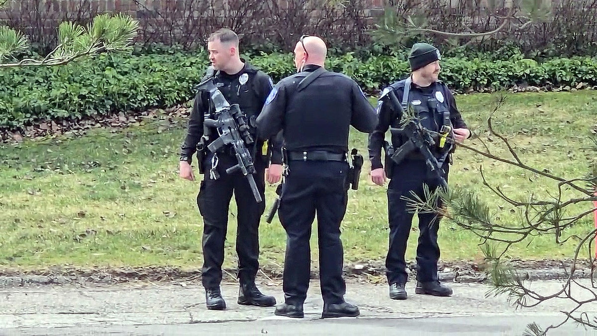 Armed police officers stand outside Temple Israel