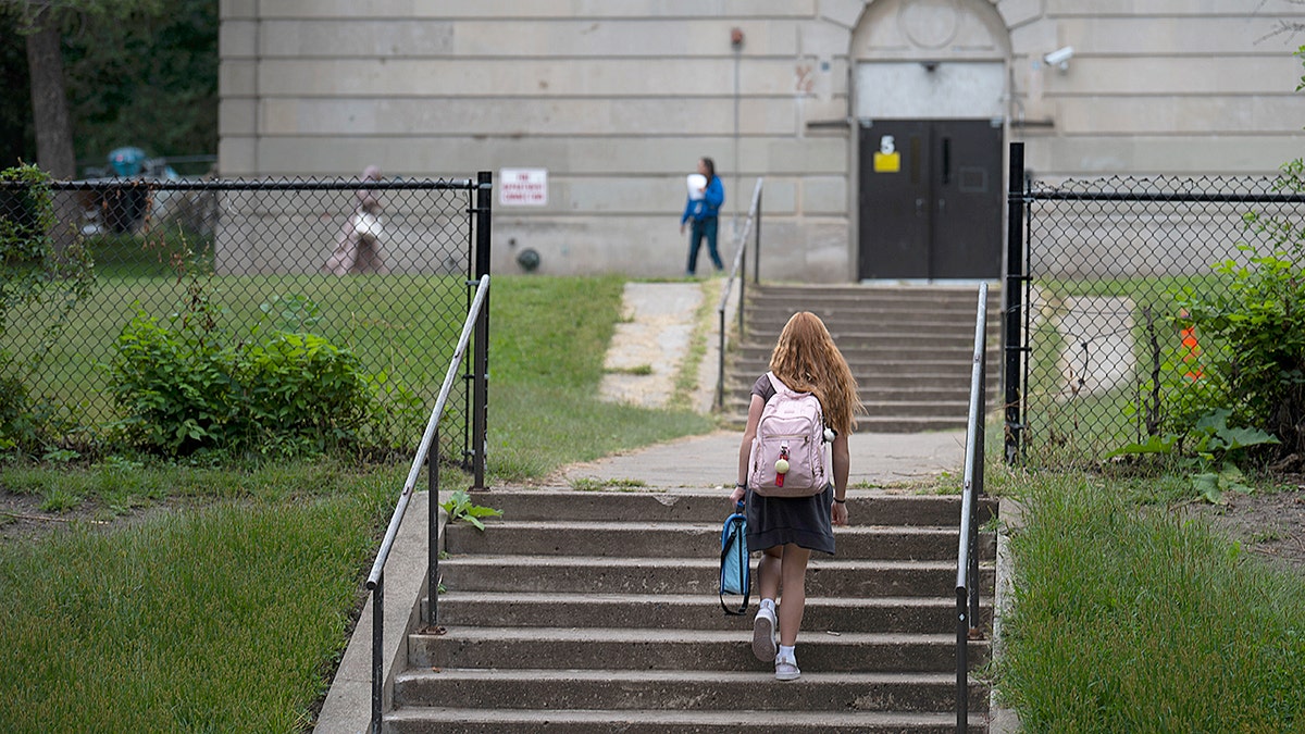 A student walks into a public school in Minnesota