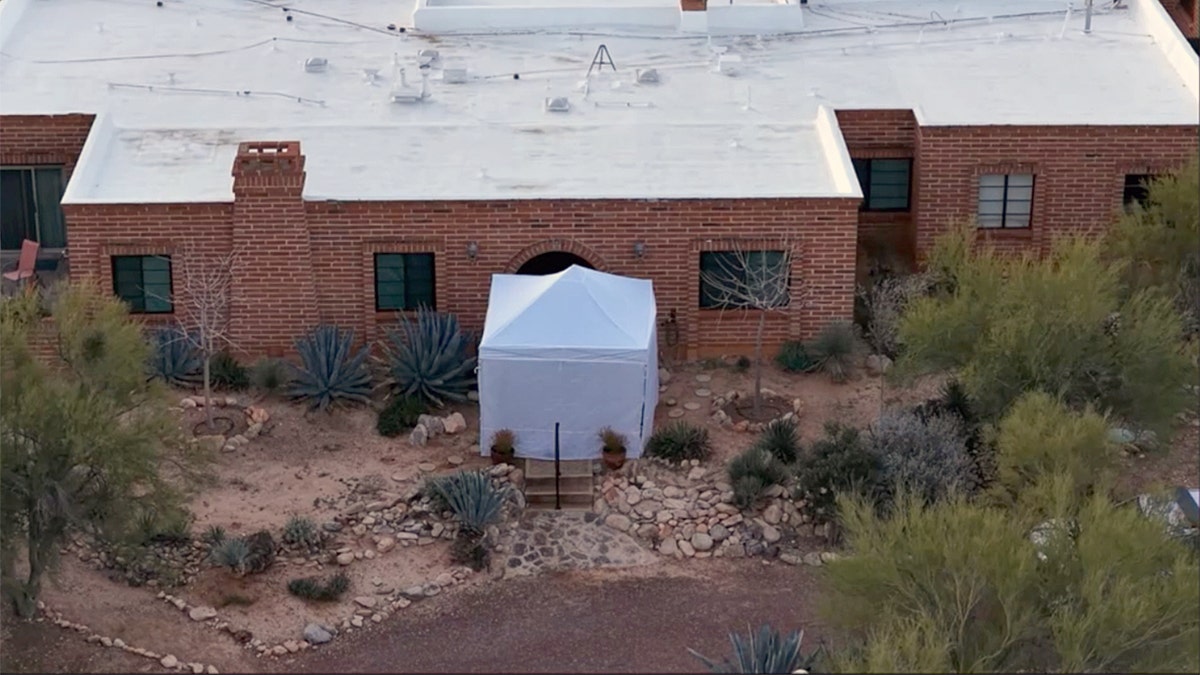 A tent outside of Nancy Guthrie's front door