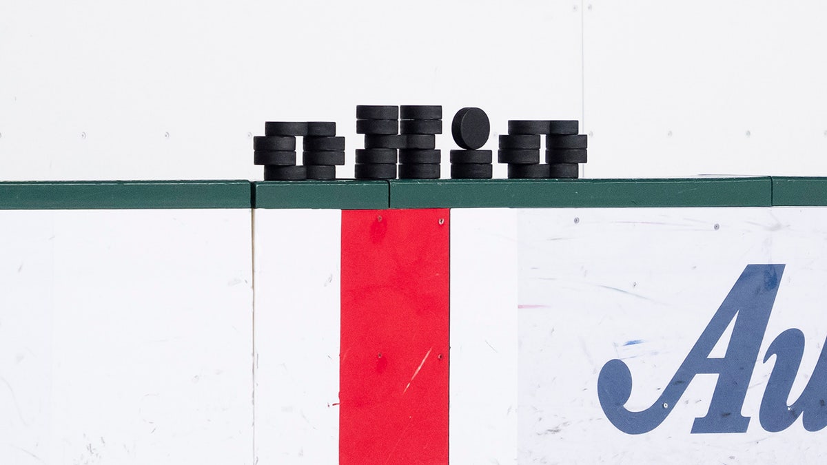 Pucks lined up on the boards