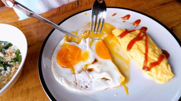 Woman cutting fried eggs