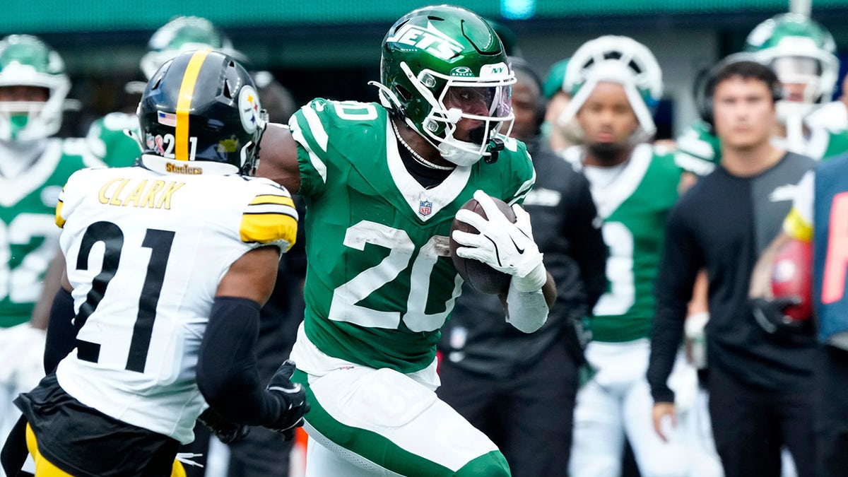 Breece Hall runs up the sideline