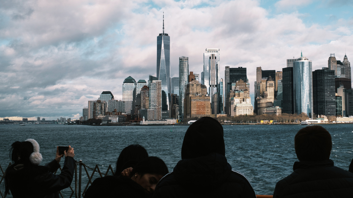 People view the NYC skyline while commuting on the Staten Island ferry.