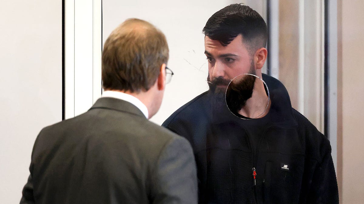 Boston Police Officer Nicholas O'Malley speaks with his lawyer.
